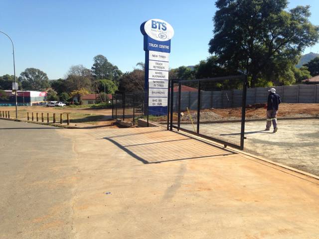Mesh fence and wide sliding gate at a truck centre entrance